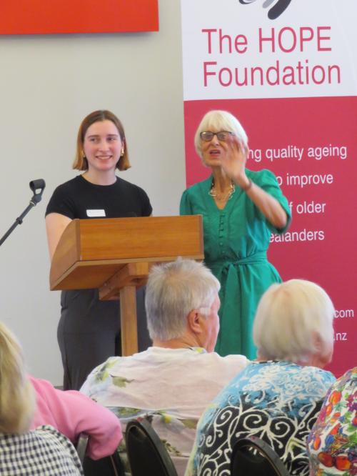 two women in from of the HOPE Foundation banner